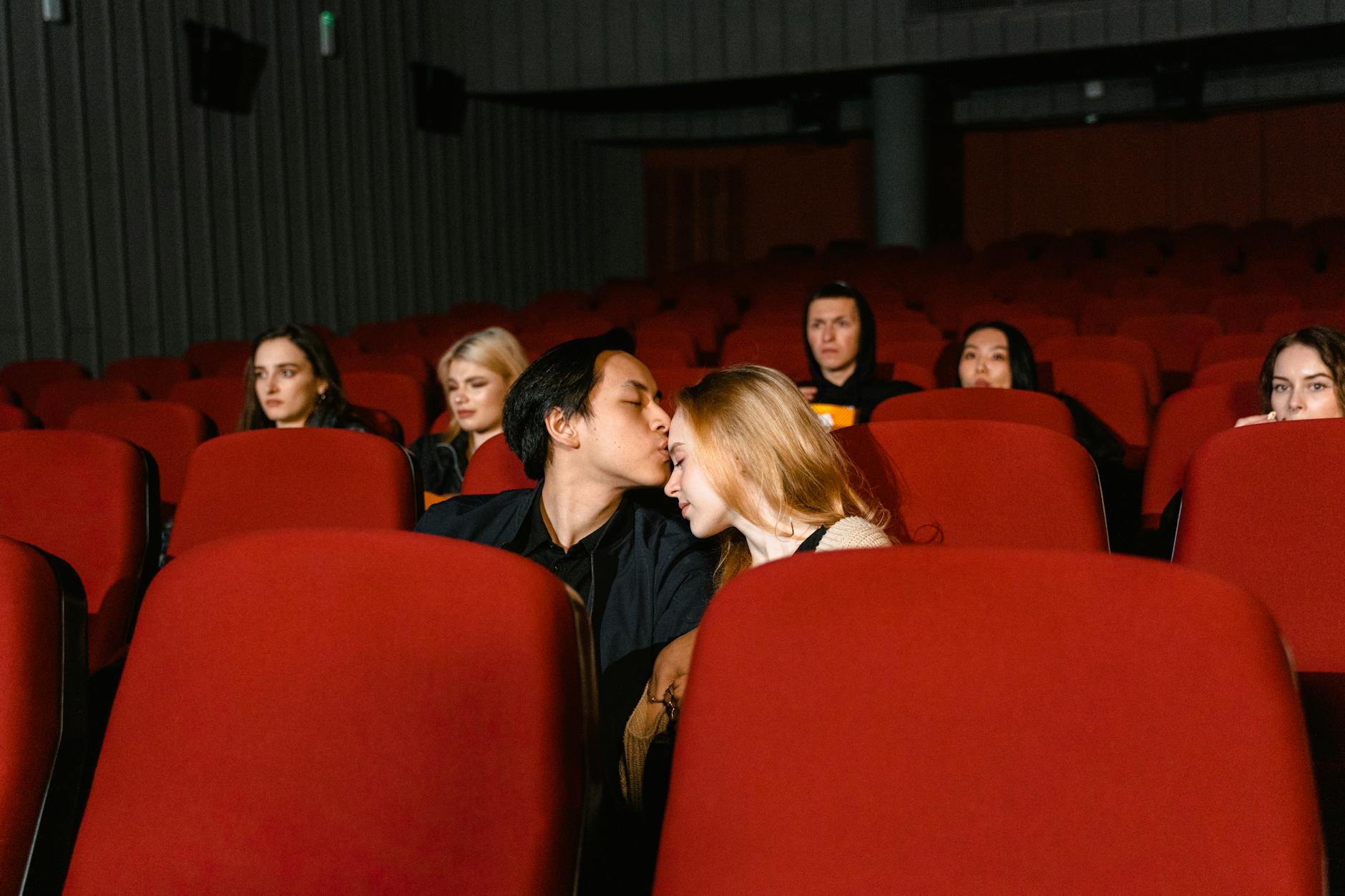 Tearful viewer watching an emotional movie with a box of tissues nearby.